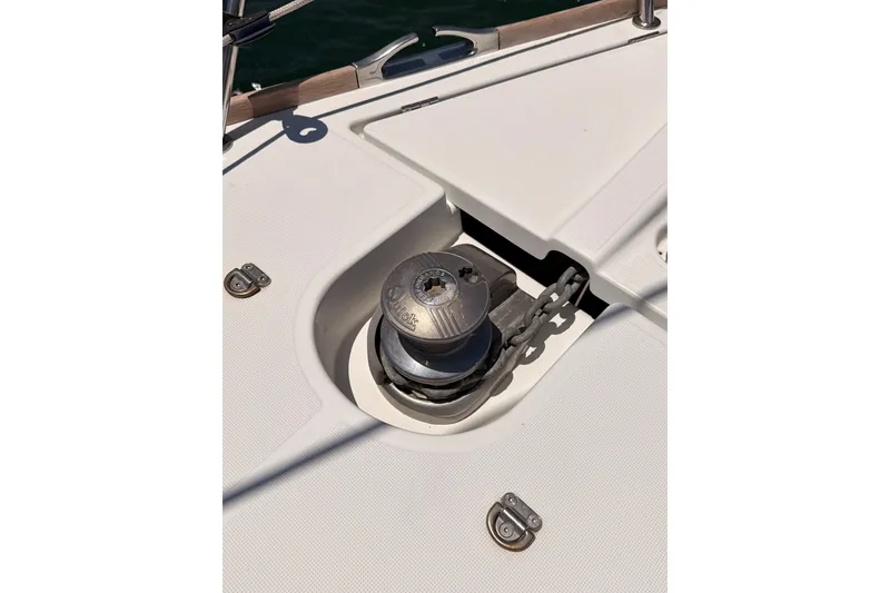 Slide: The Image of Deck detail of a 2009 Jeanneau Sun Odyssey 45 DS sailboat, featuring a winch and chain. - 32