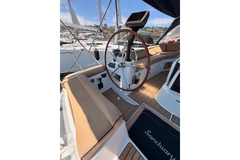 Slide: The Image of Cockpit of 2009 Jeanneau Sun Odyssey 45 DS sailboat with wooden wheel and seating. - 18
