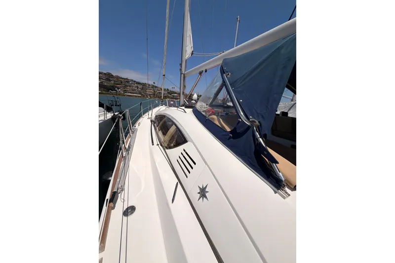 Slide: The Image of 2009 Jeanneau Sun Odyssey 45 DS sailboat with blue canopy, docked in a sunny marina. - 27