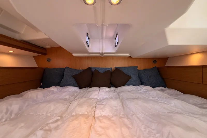 Slide: The Image of Cozy cabin interior of 2009 Jeanneau Sun Odyssey 45 DS with plush bedding and cushions. - 90