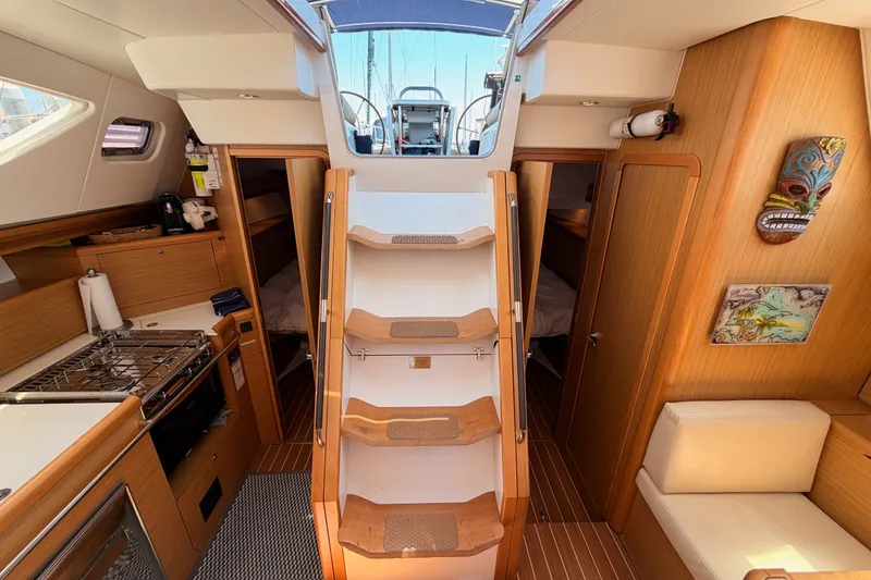 Slide: The Image of Interior of 2009 Jeanneau Sun Odyssey 45 DS sailboat, featuring wooden cabinetry and cozy seating. - 79