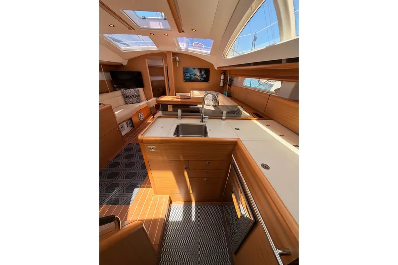 Slide: The Image of Luxurious interior of 2009 Jeanneau Sun Odyssey 45 DS yacht with modern kitchen and seating area. - 58