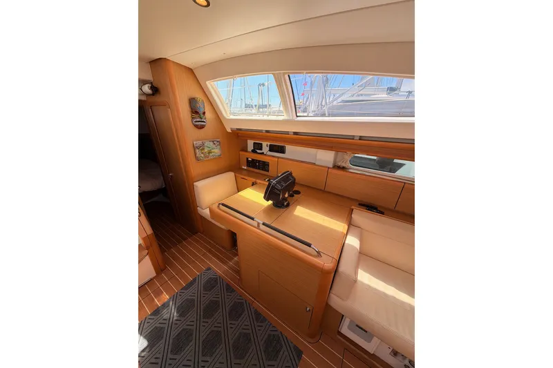 Slide: The Image of Interior of 2009 Jeanneau Sun Odyssey 45 DS yacht, featuring elegant wood finish and seating area. - 45