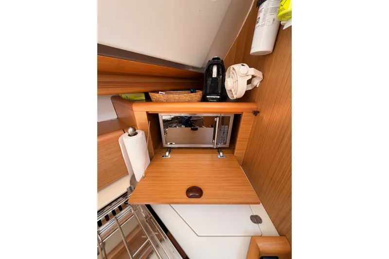 Slide: The Image of Interior of 2009 Jeanneau Sun Odyssey 45 DS yacht with wooden cabinetry and appliances. - 56