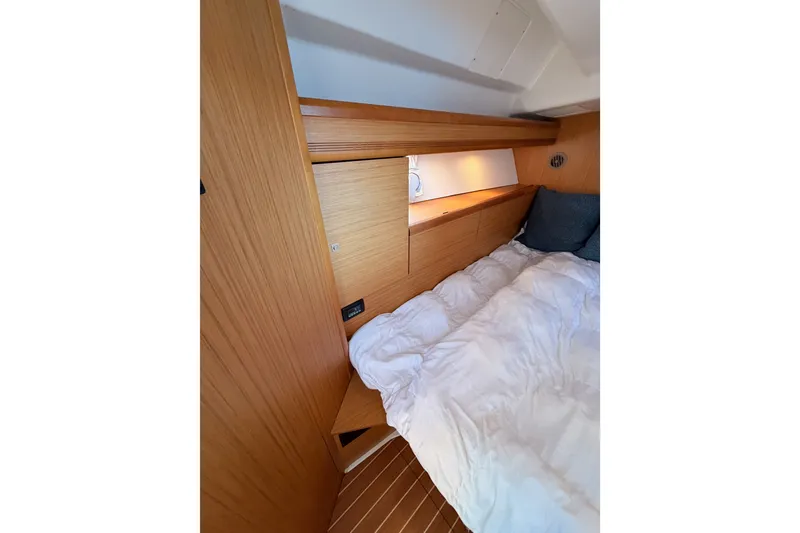 Slide: The Image of Cozy cabin interior of 2009 Jeanneau Sun Odyssey 45 DS with wooden finish and bedding. - 88