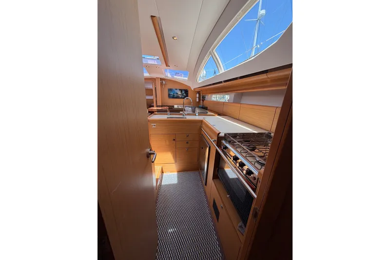 Slide: The Image of Interior of 2009 Jeanneau Sun Odyssey 45 DS yacht, featuring a modern kitchen galley. - 91