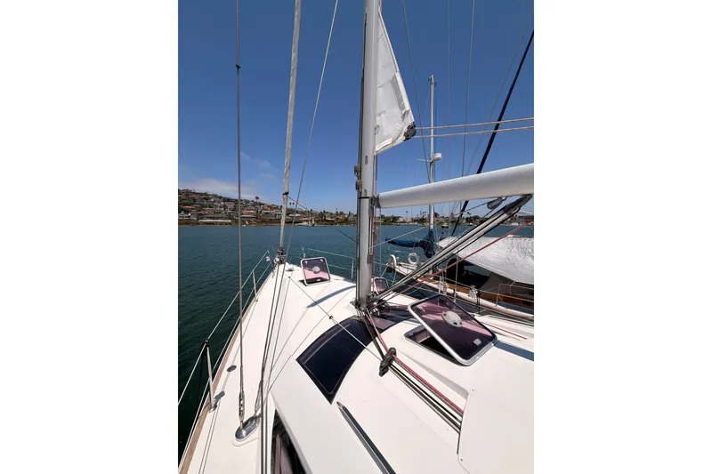 Slide: The Image of 2009 Jeanneau Sun Odyssey 45 DS sailboat deck with clear sky and waterfront view. - 28