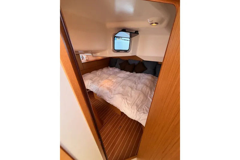 Slide: The Image of Cozy cabin interior of 2009 Jeanneau Sun Odyssey 45 DS sailboat with bed and window. - 83