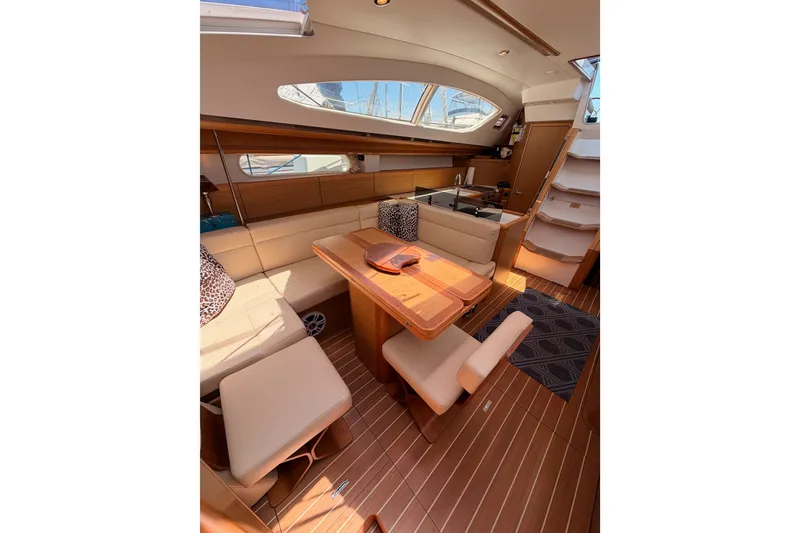Slide: The Image of Luxurious interior of 2009 Jeanneau Sun Odyssey 45 DS yacht with elegant seating and dining area. - 77