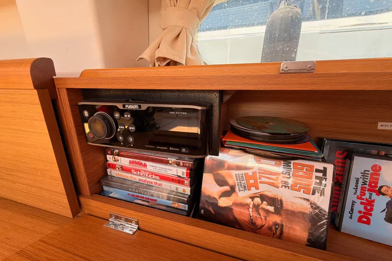 Slide: The Image of DVDs and stereo system in Jeanneau Sun Odyssey 45 DS yacht interior, 2009 model. - 51
