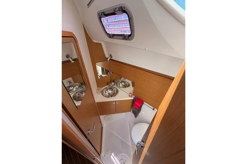 Slide: The Image of Bathroom interior of 2009 Jeanneau Sun Odyssey 45 DS yacht, featuring wood accents and stainless fixtures. - 80