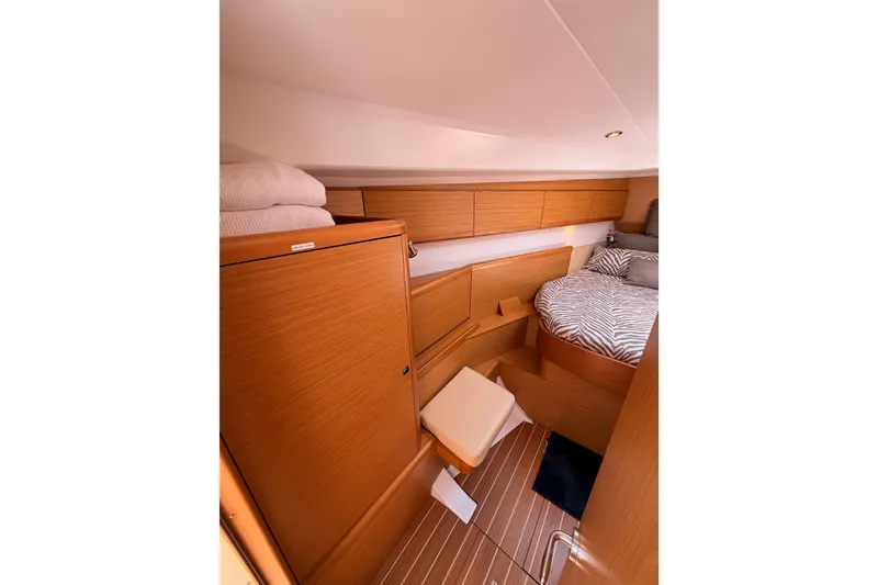 Slide: The Image of Cozy cabin interior of 2009 Jeanneau Sun Odyssey 45 DS with wood finish and zebra-patterned bedding. - 65