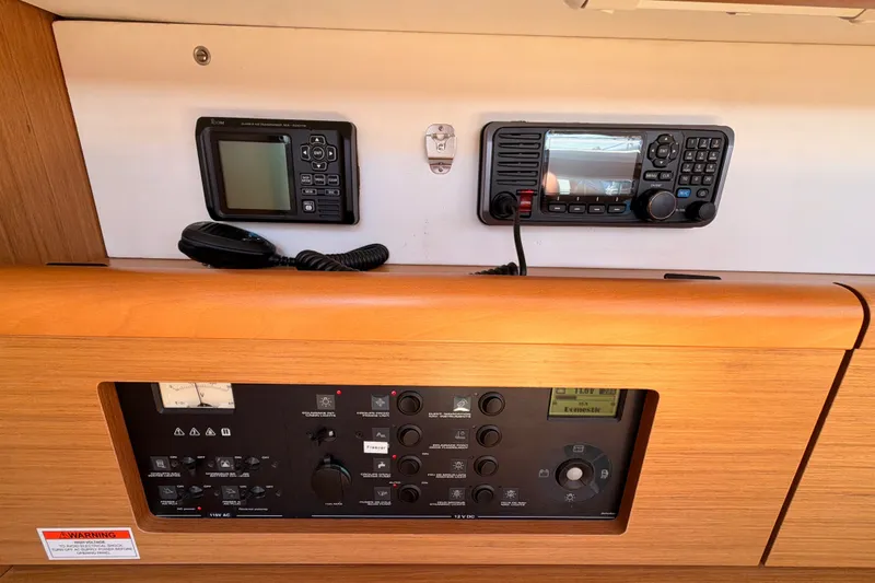 Slide: The Image of Control panel of a 2009 Jeanneau Sun Odyssey 45 DS sailboat, featuring navigation and communication equipment. - 48