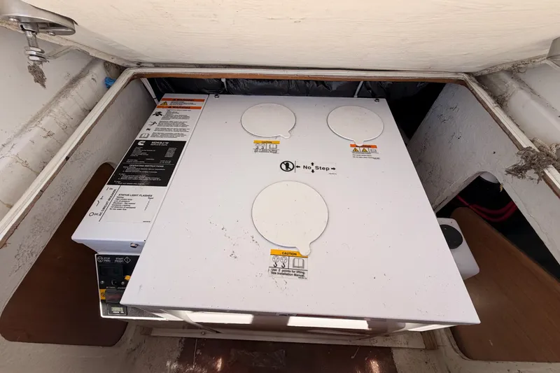 Slide: The Image of Engine compartment of a 2009 Jeanneau Sun Odyssey 45 DS sailboat, showing maintenance instructions. - 99