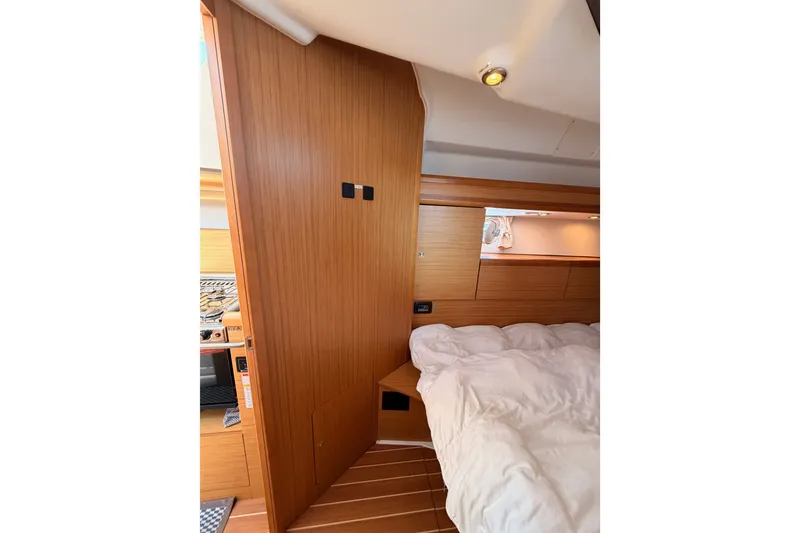 Slide: The Image of Interior of 2009 Jeanneau Sun Odyssey 45 DS yacht, featuring cozy wooden cabin and bed. - 87