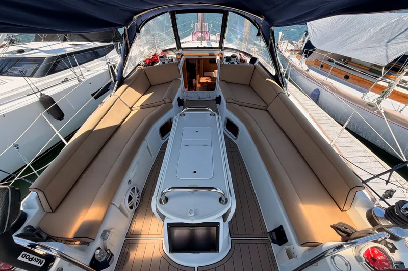 Slide: The Image of Spacious cockpit of 2009 Jeanneau Sun Odyssey 45 DS sailboat with tan seating and modern design. - 26