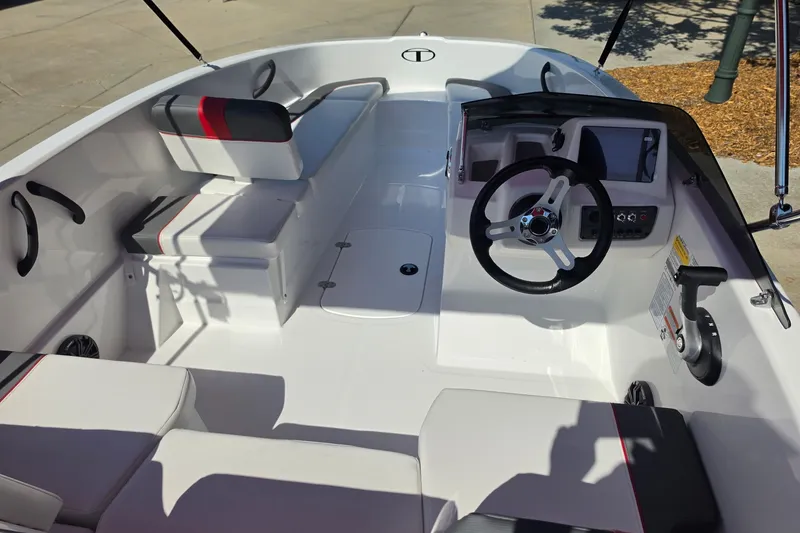 Slide: The Image of Interior of a 2027 Tahoe T16 boat featuring modern steering and seating. - 6