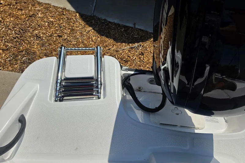 Slide: The Image of Rear view of 2027 Tahoe T16 boat with folded ladder and engine detail. - 10