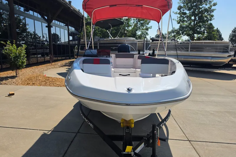 Slide: The Image of 2027 Tahoe T16 boat with red canopy on display outdoors. - 3