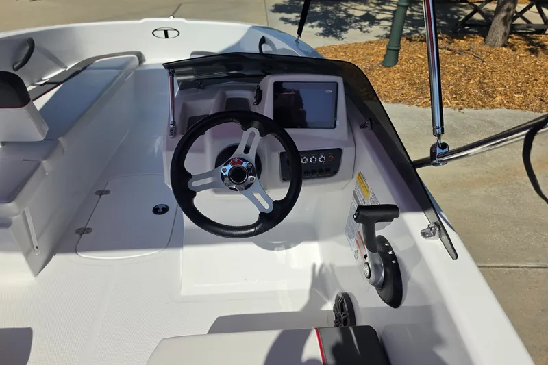 Slide: The Image of 2027 Tahoe T16 boat cockpit with steering wheel and control panel. - 7