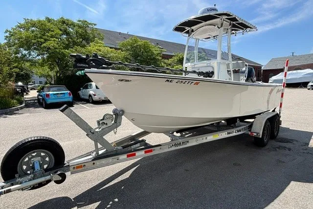 Slide: The Image of A 2023 May-Craft 20 Cape Classic on a trailer, featuring a T-top and outboard motor. - 5