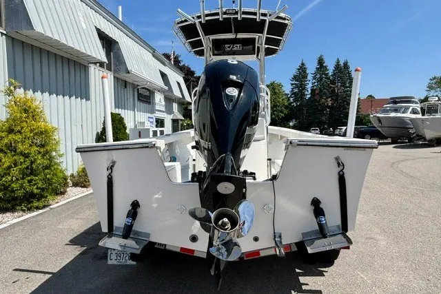 Slide: The Image of A 2023 May-Craft 20 Cape Classic boat with an outboard motor, parked in a lot. - 3