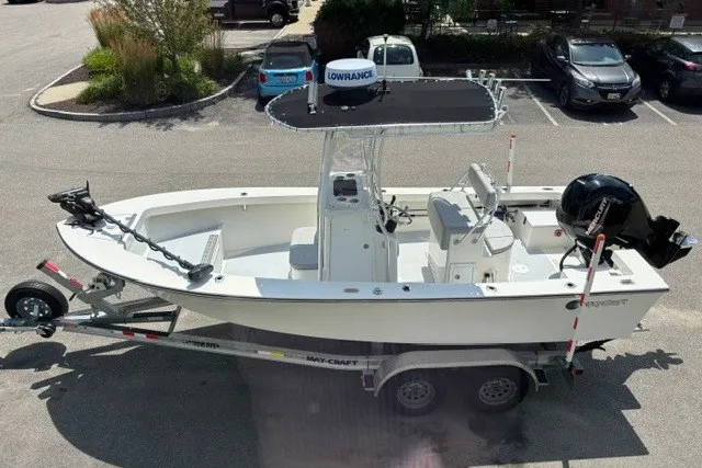 The Image of A 2023 May-Craft 20 Cape Classic boat on a trailer, featuring an outboard motor and T-top. - 0