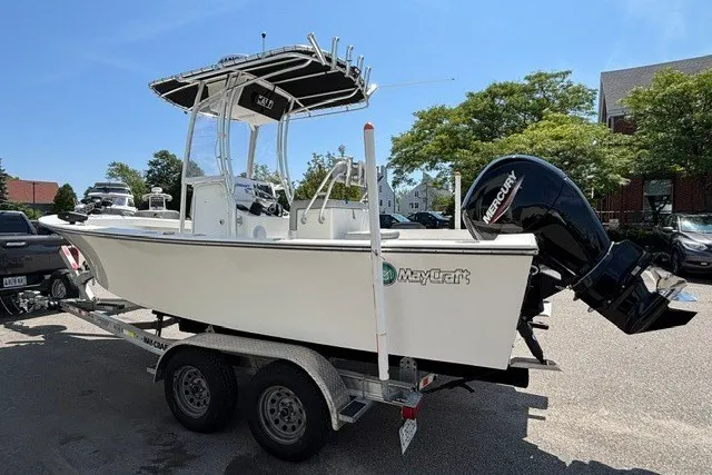 Slide: The Image of A 2023 May-Craft 20 Cape Classic boat on a trailer, featuring a Mercury outboard motor. - 4