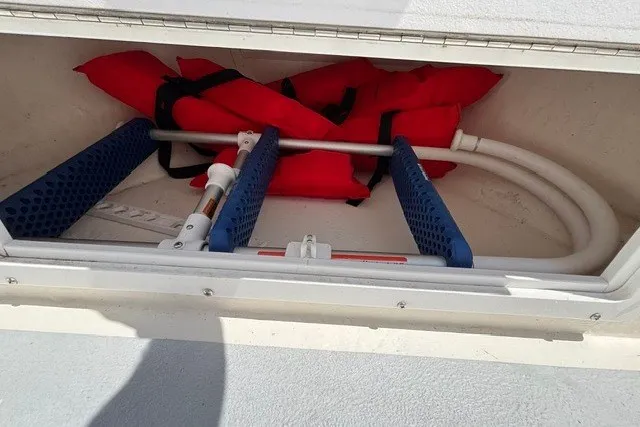 Slide: The Image of A storage compartment on a boat contains red life jackets and blue brackets. - 16
