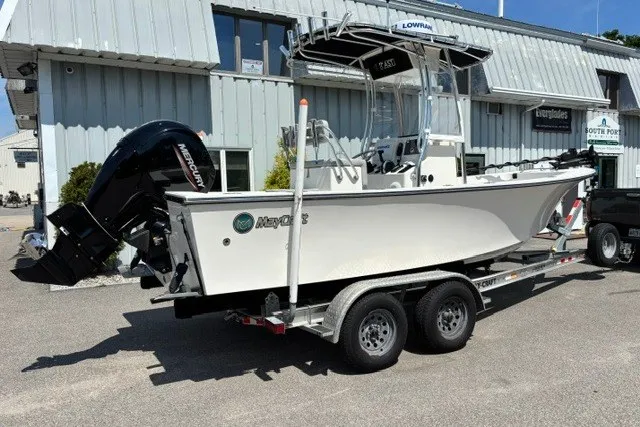 Slide: The Image of A 2023 May-Craft 20 Cape Classic on a trailer, featuring an outboard motor and T-top. - 1
