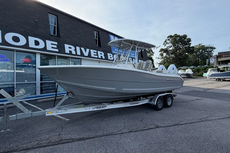 The Image of 2027 Bulls Bay 255 Center Console boat on trailer outside dealership. - 0