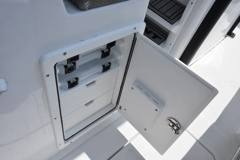 Slide: The Image of Storage compartment on a 2027 Sea Hunt Gamefish 25 boat, featuring organized tackle boxes. - 21