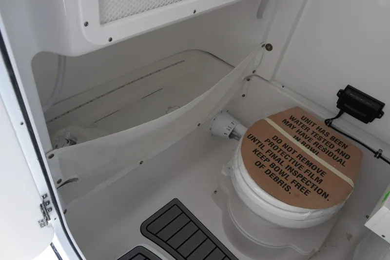 Slide: The Image of Interior of 2027 Sea Hunt Gamefish 25 boat with covered toilet and storage area. - 16