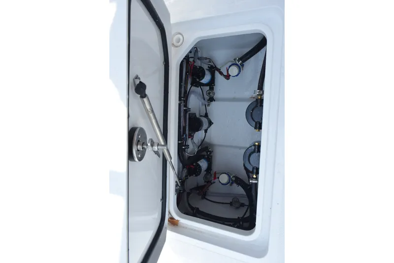 Slide: The Image of Open hatch of 2027 Sea Hunt Gamefish 25, revealing internal components and wiring. - 20