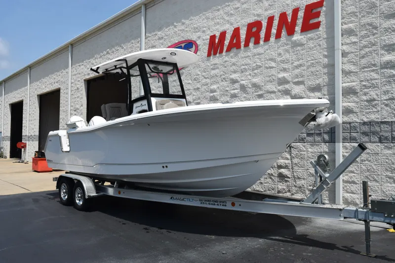 Slide: The Image of 2027 Sea Hunt Gamefish 25 boat on trailer outside marine dealership. - 2