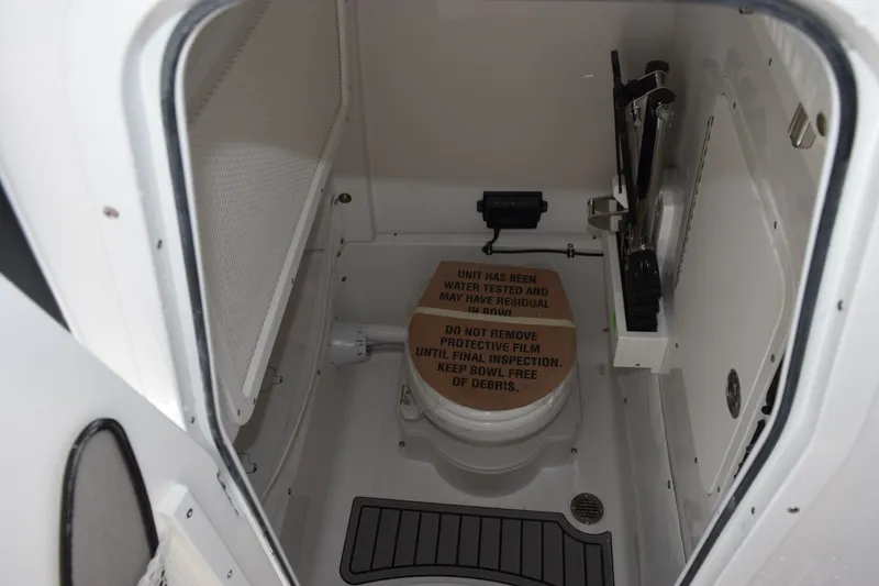Slide: The Image of Interior of 2027 Sea Hunt Gamefish 25 boat, featuring a compact marine toilet. - 15