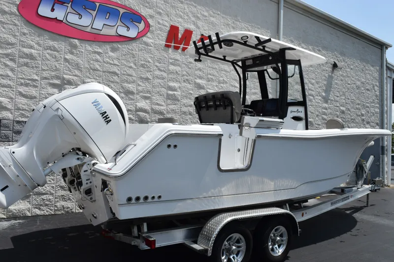 Slide: The Image of 2027 Sea Hunt Gamefish 25 boat with Yamaha engine on trailer, parked outside dealership. - 4