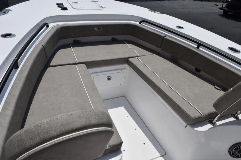 Slide: The Image of 2027 Sea Hunt Gamefish 25 boat interior with cushioned seating and storage compartment. - 12