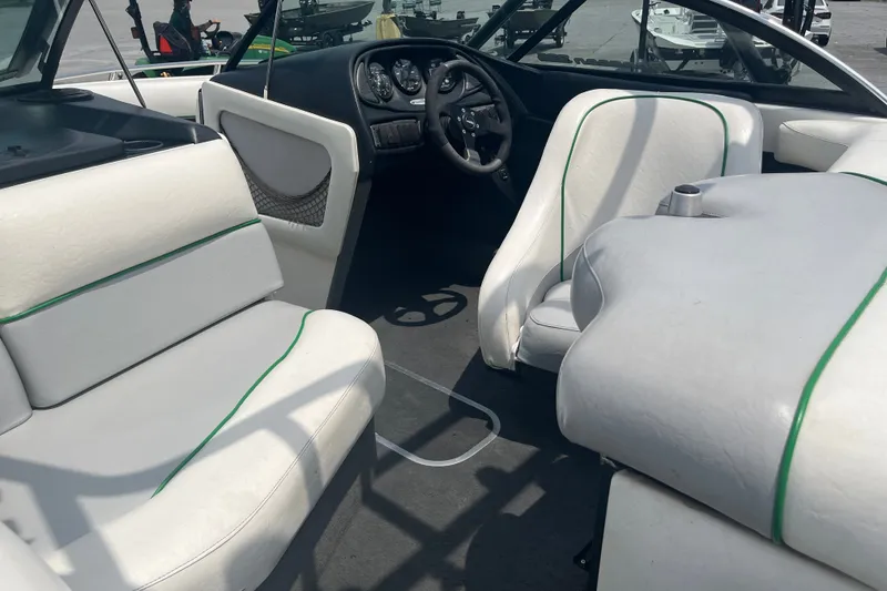 Slide: The Image of 2003 Malibu Wakesetter boat interior with white seating and steering wheel. - 8