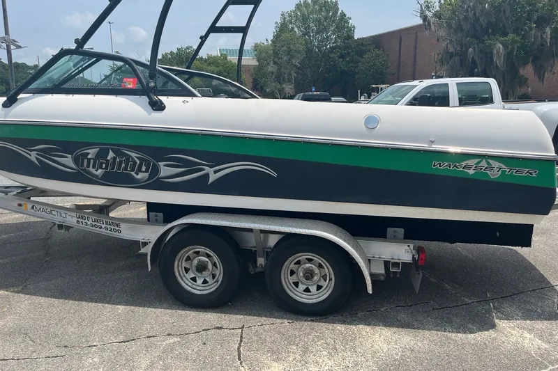 Slide: The Image of 2003 Malibu Wakesetter boat on trailer in parking lot, side view. - 3