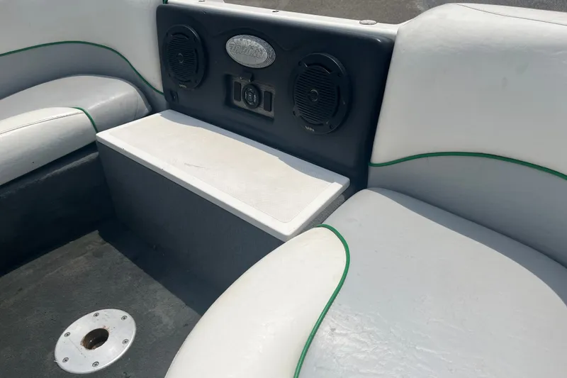 Slide: The Image of Interior of a 2003 Malibu Wakesetter boat with seating and speakers. - 7