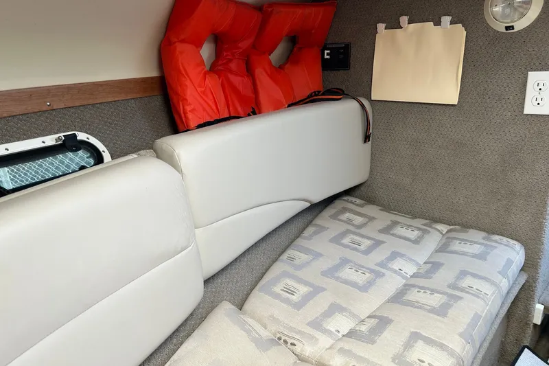 Slide: The Image of Interior cabin of 2002 Four Winns 225 Sundowner with life jackets and seating. - 11