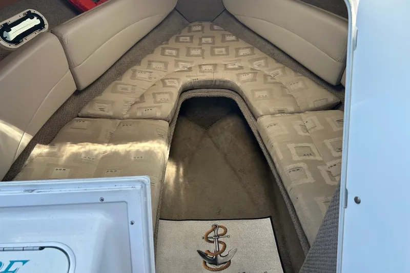 Slide: The Image of Interior cabin of 2002 Four Winns 225 Sundowner boat with cushioned seating. - 12