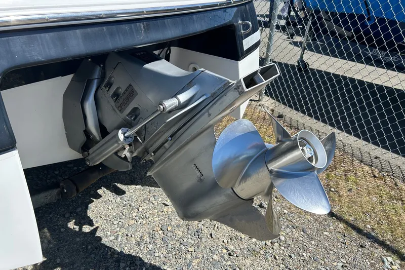 Slide: The Image of Outboard motor of 2002 Four Winns 225 Sundowner boat, featuring a shiny propeller. - 3