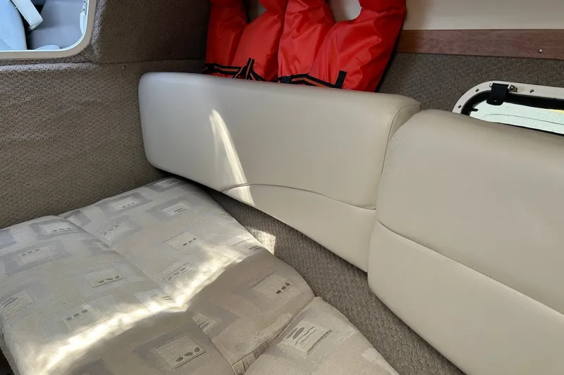 Slide: The Image of Interior cabin of 2002 Four Winns 225 Sundowner with cushions and life jackets. - 10