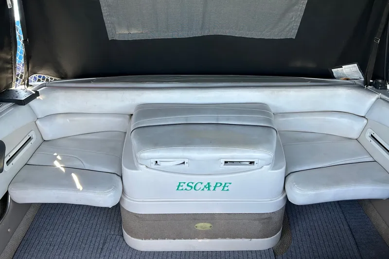 Slide: The Image of Interior seating of 2002 Four Winns 225 Sundowner boat, featuring white upholstery. - 4