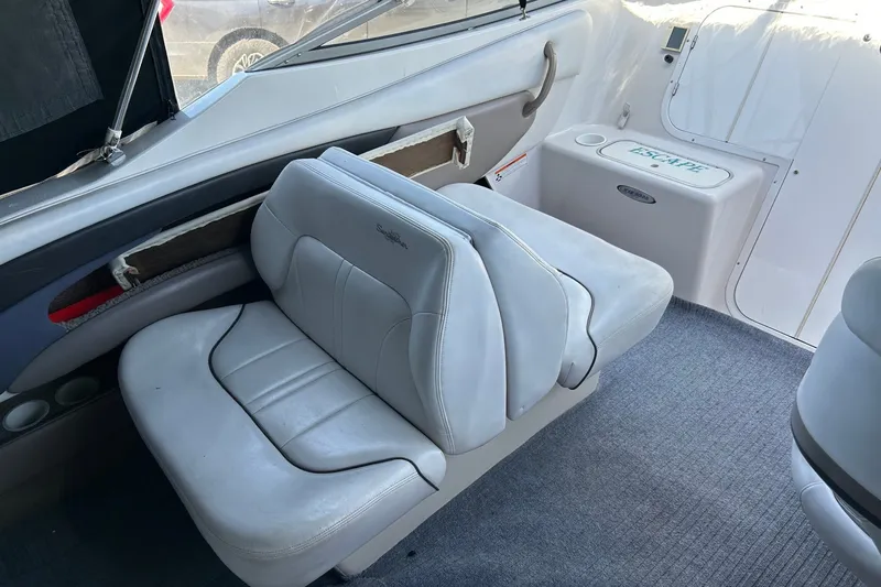 Slide: The Image of Interior of 2002 Four Winns 225 Sundowner boat with white seating and carpeted floor. - 5