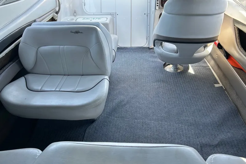 Slide: The Image of Interior of 2002 Four Winns 225 Sundowner boat with white seating and carpeted floor. - 15