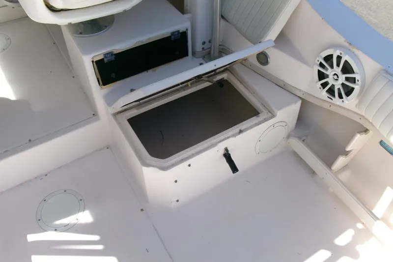 Slide: The Image of 2001 Grady-White Gulfstream 232 boat interior with open storage compartment and speaker. - 21