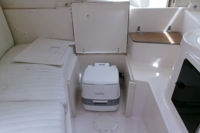 Slide: The Image of Interior of 2001 Grady-White Gulfstream 232 boat with portable toilet and seating area. - 15